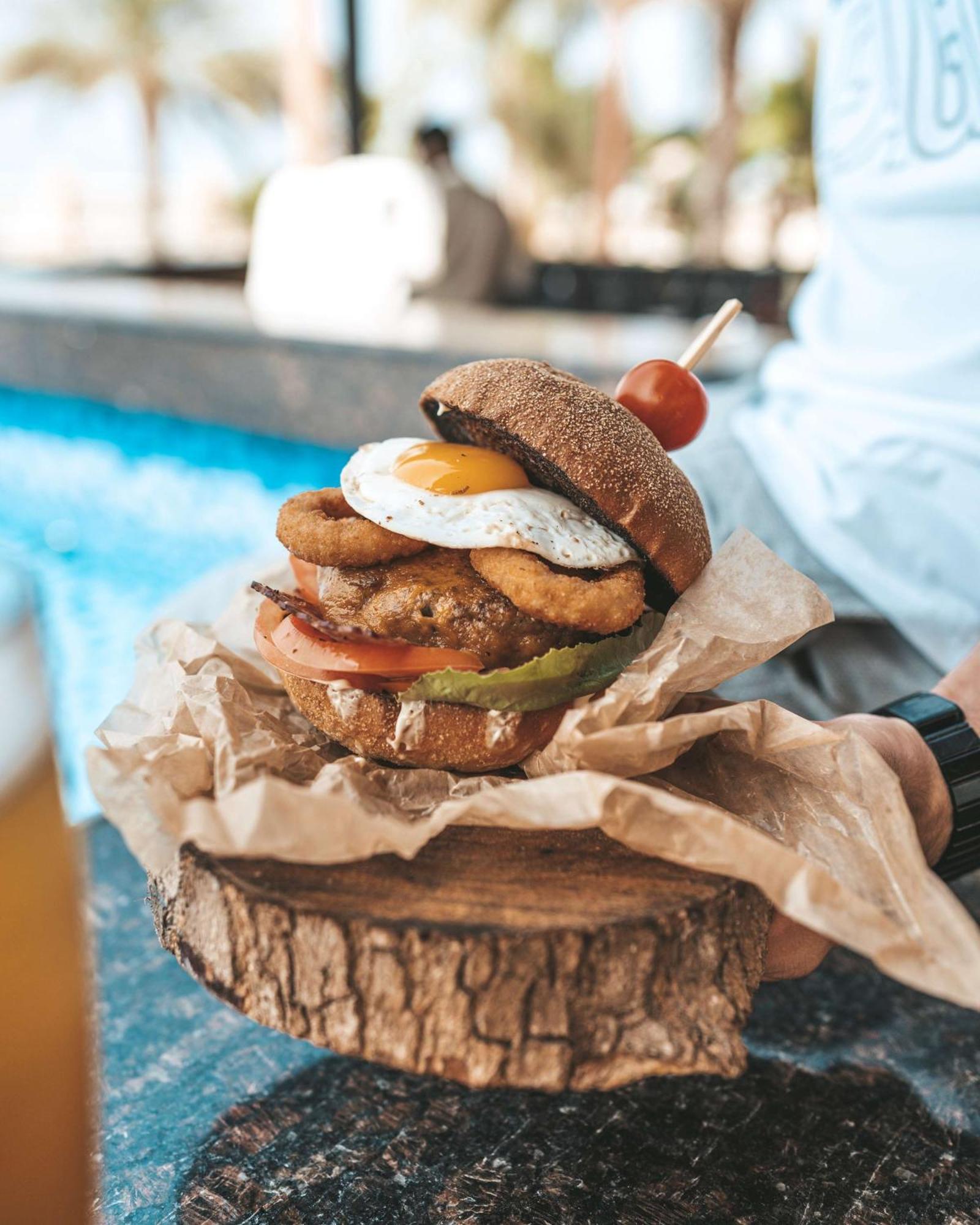 Radisson Blu Hotel & Resort, Sohar Exterior photo A burger with a fried egg